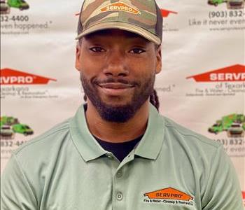 A SERVPRO employee in front of SERVPRO backdrop