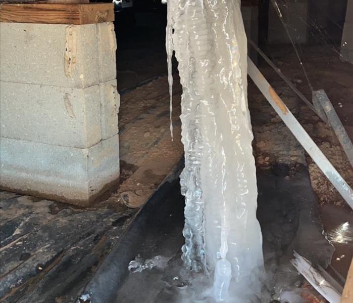 busted pipe that is frozen in a crawl space